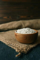 Flour in a wooden bowl on burlap