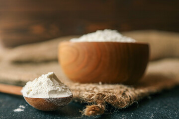 Flour in a wooden bowl on burlap