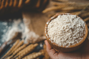 Flour in a wooden bowl, fresh homemade bread and ears of corn, bakery banner