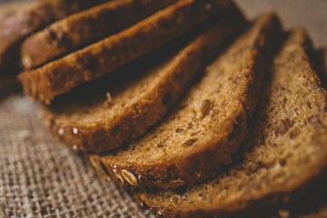 Sliced rye bread on cutting board. Whole grain rye bread with seeds