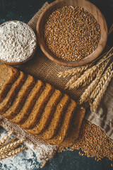 Sliced rye bread on cutting board. Whole grain rye bread with seeds
