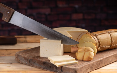 Cheese, details of beautiful and delicious cheese on rustic wooden surface, selective focus.