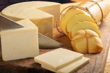 Cheese, details of beautiful and delicious cheese on rustic wooden surface, selective focus.