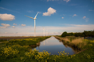 wind turbines in the field near the canal
