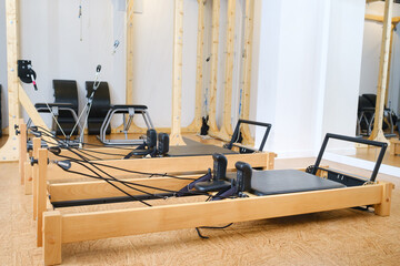 the reformer machine in the pilates room. Yoga equipment