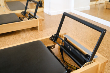 the reformer machine in the pilates room. Yoga equipment