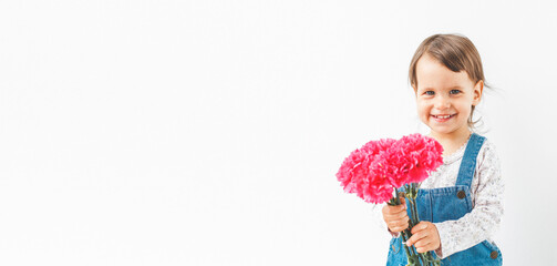 white banner baby girl standing on a white background with a bouquet of bright pink carnation flowers, space for text, copyspace