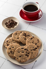 Delicious chocolate chip cookies with a red coffee cup. Breakfast. 