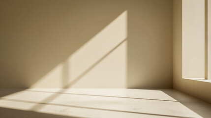 A room with a window and a wall. The room is empty and the sunlight is shining on the wall