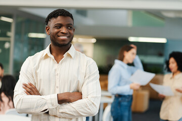 Confident successful African American man, young businessman, manager with crossed arms
