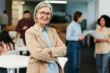 Obraz premium Cheerful smiling senior woman wearing stylish eyeglasses, professional CEO, businesswoman