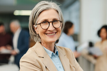 Beautiful smiling mature woman, businesswoman, CEO wearing eyeglasses and formal wear