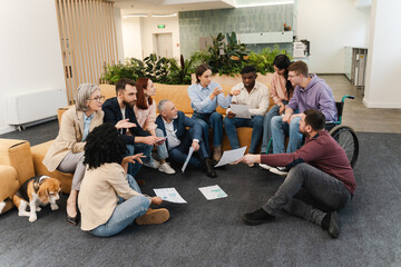 Group of businesspeople working together holding graphs in modern office. Concept of meeting