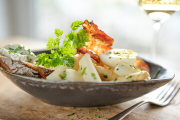 Bowl of asparagus salad with egg and bacon on wooden table. Background for halthy nutrion and...