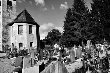 A cemetery with a small building in the background