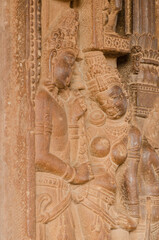 Sculpture or carving of Man and women in traditional form of indian art, 7th century Hindu temple, Aihole, Karnataka, India.