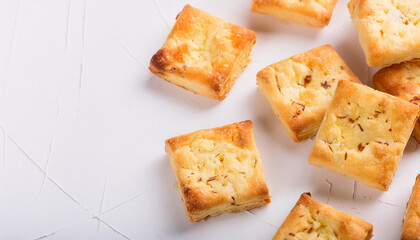 Freshly baked cheese crackers on white table. Tasty food. Delicious snack. Baked goods. Top view.