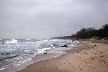 Deserted shore of the Baltic Sea in winter with a beach and waves. Zelenogradsk. Kaliningrad region. Russia