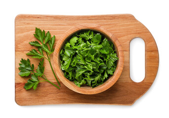 Chopped parsley and leaves on a kitchen board on a white background. Top view