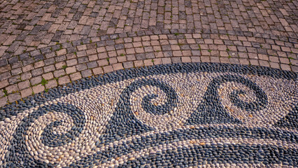 wavy floor mosaic created by arranging sea stones