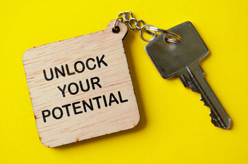 Unlock your potential text engraved on wooden key chain. Motivational concept