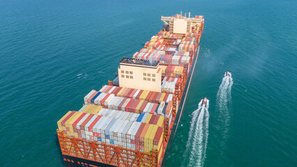 Stern Cargo Container ship the ocean ship carrying container and running for import export concept...