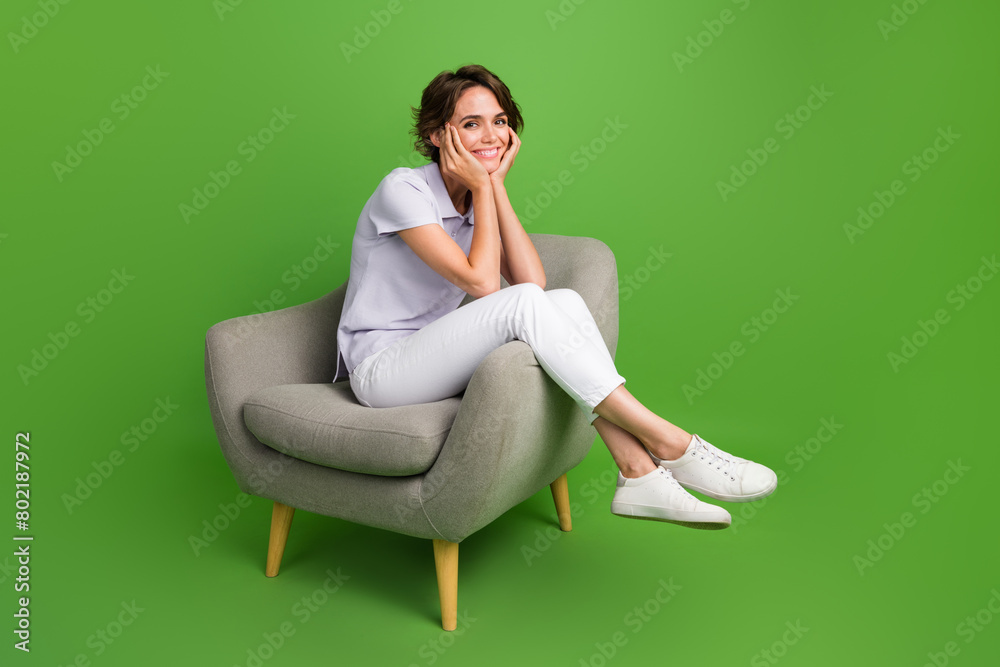 Sticker full length photo of funky dreamy girl dressed grey polo sitting chair arms cheeks empty space isola