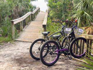 Two bicycles parked together by a beach access ramp on a barrier island in southwest Florida, for...