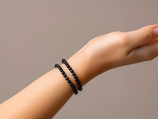Black bracelet on hand mockup, close up, on neutral background