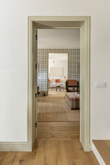 View through the doors of consecutive living rooms decorated with rustic-style furniture