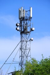 Mobile phone mast on blue sky background