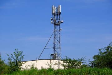 Mobile phone mast on blue sky background