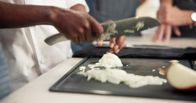 Chef, hands and onions for cutting in kitchen, teaching and learn for professional skills. Restaurant, food or vegetable chop for culinary student person, ingredient and cooking with speed for recipe