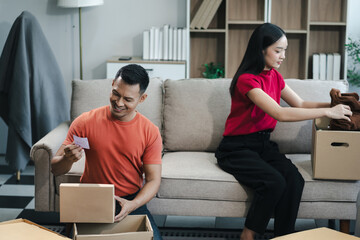 young couple helps put things in boxes and prepares to move to a new house.