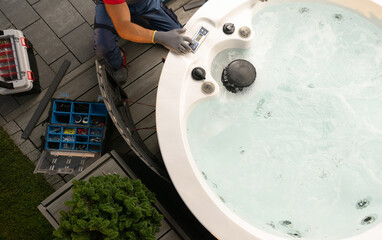 Professional Garden SPA Worker Servicing Modern Hot Tub