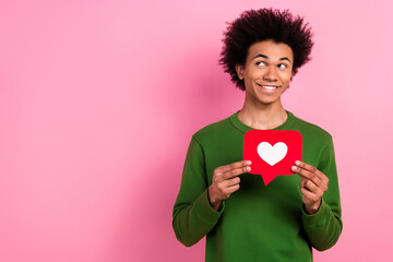 Photo of happy positive guy hold heart like look empty space isolated pastel color background