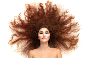A young beautiful brunette woman with scattered long luxurious hair on a white background.