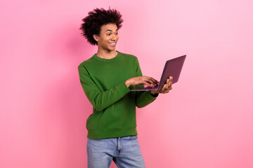 Photo of happy positive guy worker using netbook chatting isolated pastel color background