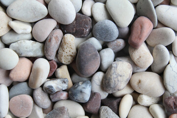 Background texture of pebbles or small river stone, flat lay or top view