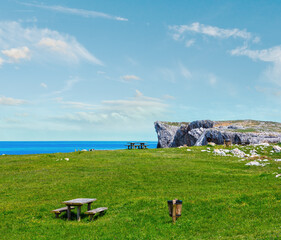 Place of rest (table with benches) on summer blossoming coast near Camango, Asturias (Spain). 