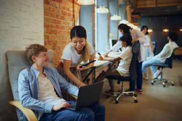 Creative hub. Co-working studio filled with multiethnic people, employees, freelancers cooperating...