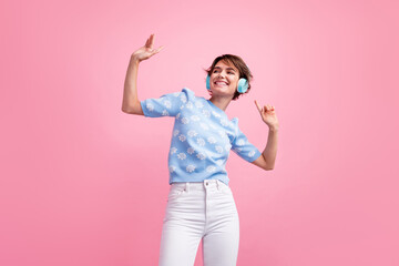 Portrait of cheerful nice person enjoy favorite song headphones dancing isolated on pink color background
