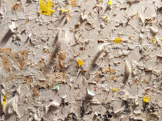 Tattered Posters on a Weathered Urban Wall. Layers of torn posters creating a textured collage....