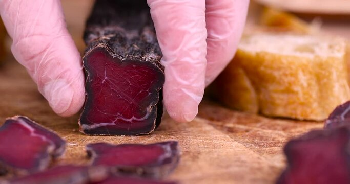 red beef jerky cut into pieces, pieces of soft dried beef meat close-up
