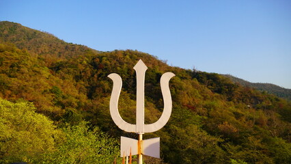 a trident with mountains background