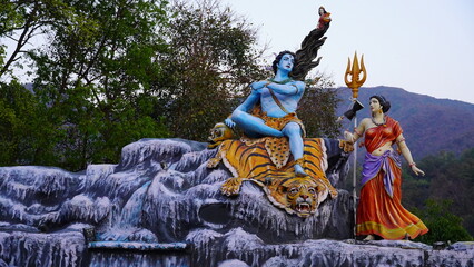 figurine of shiva sitting on mountains