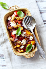 Penne pasta baked with peppers, red onion and mozzarella. Top view. 