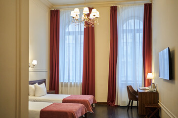 Two beds in a hotel room in a tourist resort. The interior of the double room is in a modern...
