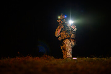 Fototapeta premium Soldiers ready to fire during Military Operation at night