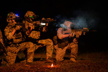 Naklejka premium Soldiers ready to fire during Military Operation at night